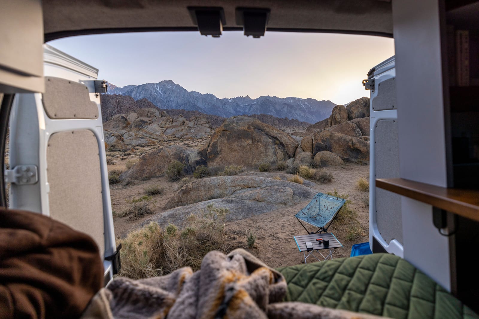 The view from inside a camper van, parked facing the mountains.